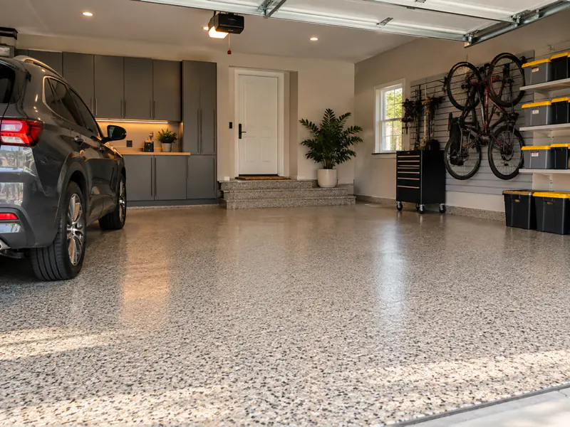 Illustrative clean residential garage with decorative coated flooring
